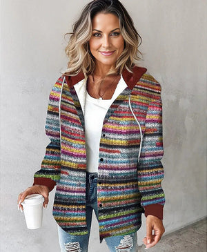 Woman wearing colorful Highland Plaid Shacket with hood and button-front closure holding coffee cup
