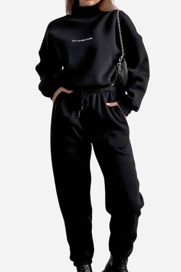 Black Storm Sweater Mock Neck athleisure set with relaxed fit and adjustable waist worn by a woman