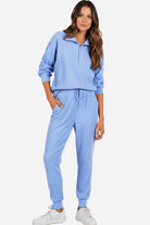 Unisex half-zip pullover and sweatpants set in light blue polyester blend for casual comfort and style