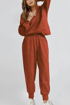 Unisex half-zip pullover and sweatpants set in rust color for casual comfort and style
