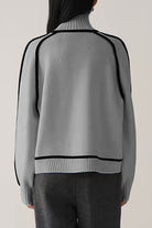 Back view of gray Zero Itch Turtleneck Sweater with black contrast trim and relaxed fit