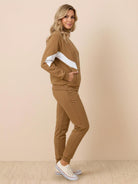 Woman wearing a colorblock comfort tracksuit with contrast curved panels and a stand collar jacket