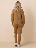 Woman wearing colorblock comfort tracksuit with contrast curved panels and relaxed fit