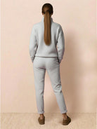 Woman wearing Warm & Easy Two-Piece Set in light gray, back view, relaxed fit sweatshirt and pants.
