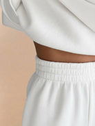 Close-up of white Warm & Easy Two-Piece Set showing soft fabric and elastic waistband of matching pants.