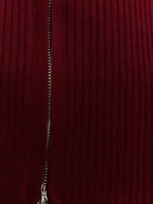 black zip-up knit cardigan jacket with vertical ribbing and high neckline on white background