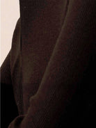 black zip-up knit cardigan with vertical ribbing and high neckline on white background