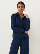 Women's wrinkle-free polo set with structured quarter-button top and high-waisted pants in breathable fabric