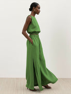 Two-piece lightweight linen-blend set with sleeveless top and wide-leg pants featuring elastic waistband and side slits for breathability