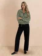 Cropped textured baseball jacket with full zipper, elastic cuffs, and waistband, styled for casual wear