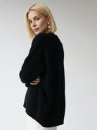 Oversized crew neck knit sweater with drop shoulders and ribbed cuffs in neutral color