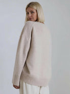 oversized crew neck knit sweater with drop shoulders and ribbed cuffs in neutral color