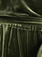 Woman wearing deep V-neck velvet suit with long sleeves and wide-leg pants