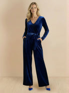 Deep V-neck velvet suit with long sleeves, removable waist tie, and wide-leg pants in soft structured fabric