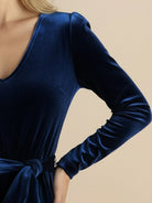 Woman wearing a deep V-neck velvet suit with long sleeves and wide-leg pants at evening event