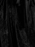 woman wearing a deep V-neck velvet suit with long sleeves and wide-leg pants