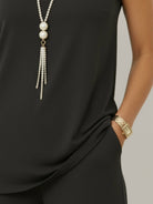 Woman wearing open-front three-piece co-ord with longline cardigan, tank top, and wide-leg trousers in lightweight knit fabric