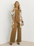 Woman wearing open-front three-piece co-ord with longline cardigan, tank top, and wide-leg trousers