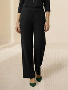 Woman wearing open-front three-piece co-ord with longline cardigan, tank top, and wide-leg trousers