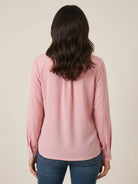 White pleated V-neck long-sleeve blouse with button cuffs and relaxed fit