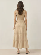 Smocked sleeveless maxi dress with tiered skirt and side pockets in lightweight polyester fabric