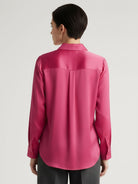 Silk-finish button front shirt with smooth fabric, relaxed fit, and curved hem in polished white