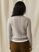 100% wool cable-knit sweater with slim fit and stand collar buttons up for warmth