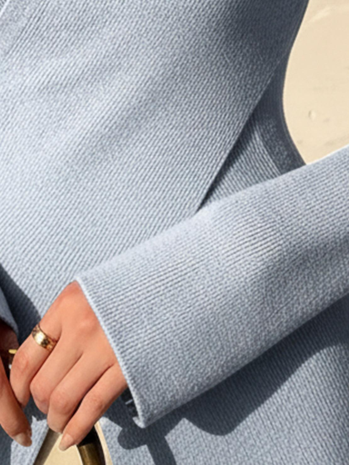 Slim fit asymmetric wrap ribbed knit top with diagonal button closure and flared cuffs