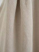 Lightweight cotton-linen empire waist dress with natural crinkle texture and deep pockets