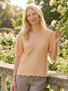 Floral jacquard pleated top with 3D floral texture, flutter sleeves, and relaxed A-line silhouette