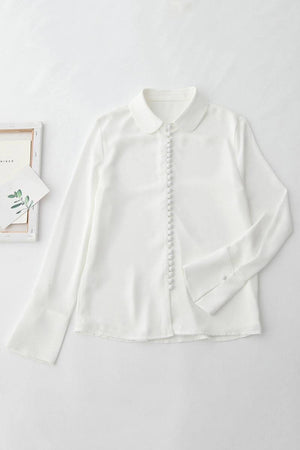 White Bayam Blouse with button-down front and classic collar, made from 100% polyester, ideal for work or casual wear