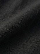 White Tencel-linen pleated wide-leg pants with structured waist and flowy silhouette