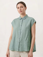 100% linen two-way button blouse with Peter Pan collar and cap sleeves in relaxed A-line silhouette