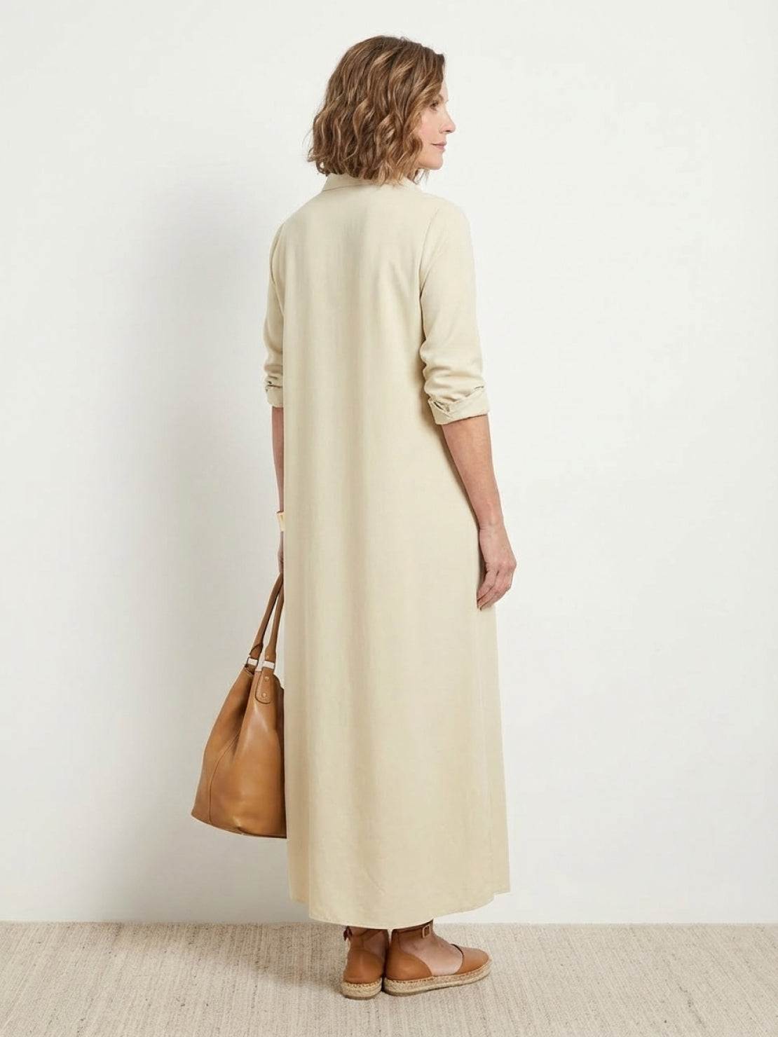 Wrinkle-free maxi button-down dress with point collar, chest pockets, long roll-up sleeves, and side slits for movement