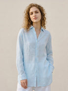 100% linen pinstripe shirt with loose fit, drop shoulders, long sleeves, and curved hem