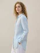 100% linen pinstripe shirt with loose fit, drop shoulders, curved hem, and button cuffs