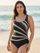Curve-Fit open-back swimsuit with scoop front, adjustable straps, and diagonal back panels for structured, modern style.