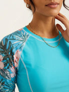 Long-sleeve UV rash guard with tropical print sleeves and matching swim shorts set