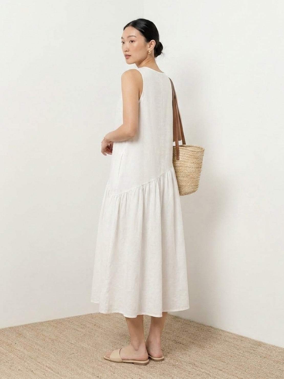 Lightweight cotton-linen summer midi dress with loose fit and tiered skirt in natural fabric texture