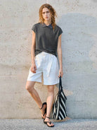 White high-rise linen belted shorts with relaxed wide-leg fit and matching belt detail