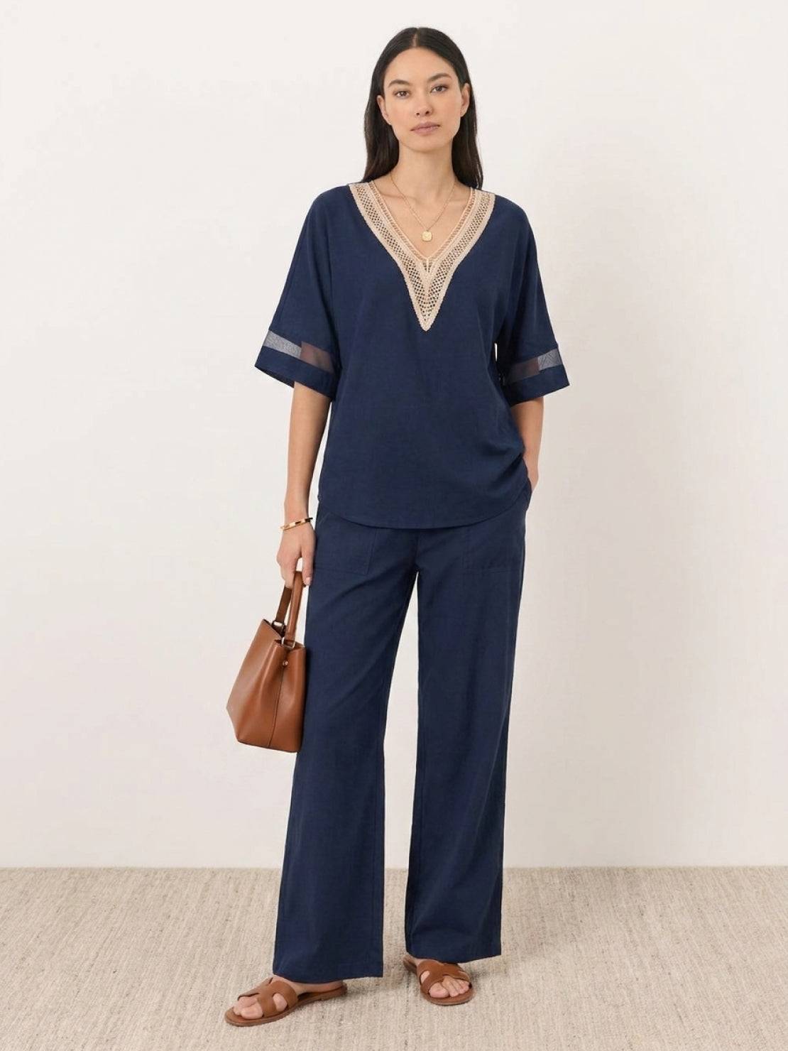 Mature woman wearing lightweight linen top with relaxed boxy fit and button details