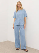 woman wearing 100% cotton navy blue two-piece set with button-front top and wide-leg pants