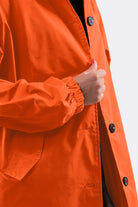 Orange water resistant oversized windbreaker jacket with button closure and elastic cuffs