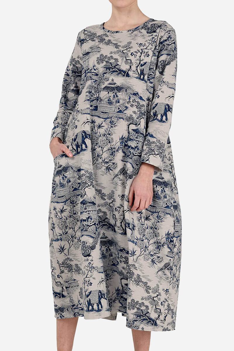 Woman wearing a loose fit Japanese Porcelain Print midi dress with 3/4 sleeves and two front pockets