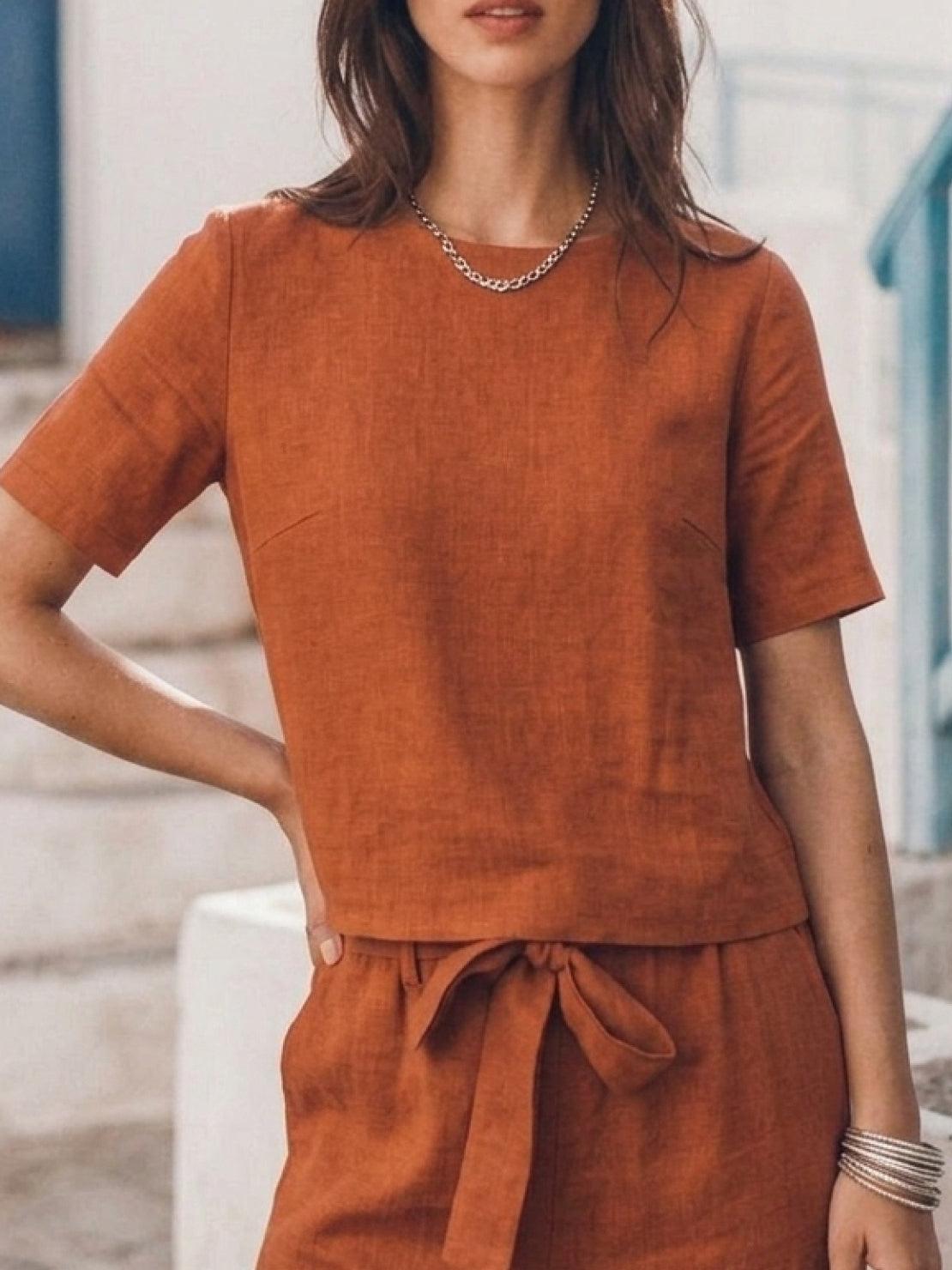 Woman wearing relaxed monochrome cotton linen set with short-sleeve top and straight-leg pants