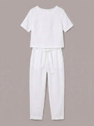 Woman wearing breathable 100% cotton linen set with relaxed short-sleeve top and straight-leg pants in monochrome tones
