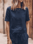 Woman wearing relaxed cotton-linen set with short sleeve top and straight-leg pants in monochrome hues
