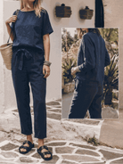 Flat lay of breathable cotton-linen set featuring relaxed short-sleeve top and straight-leg pants in monochrome tones