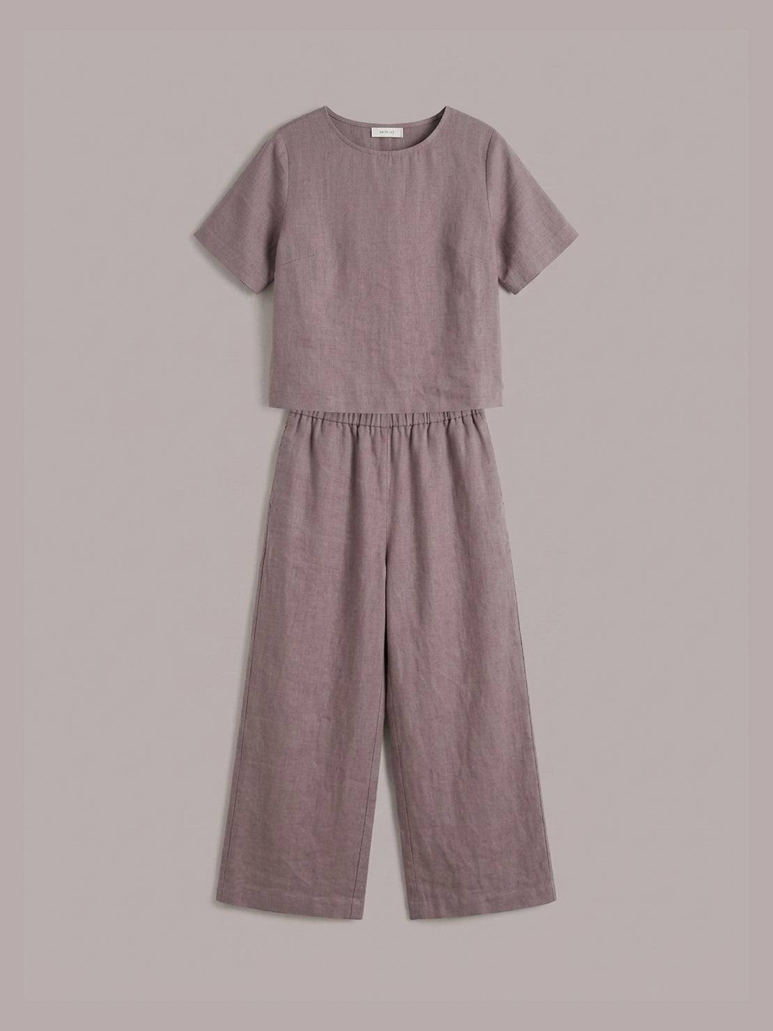 Woman wearing a soft cotton loose fit co-ord set with a relaxed boxy top and wide-leg trousers in a light, breezy fabric