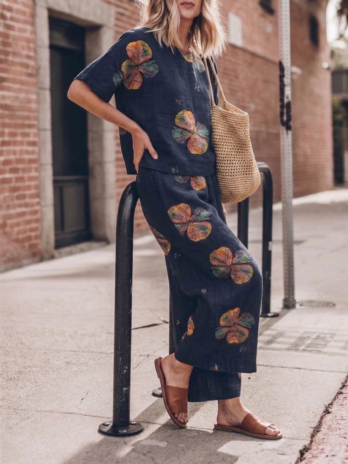 Woman wearing a soft cotton loose fit co-ord set with a relaxed short-sleeve top and wide-leg trousers